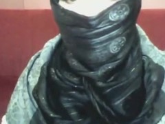 Bored arab beauty in hijab plays on her calculator